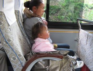 Mother and child seated on a public bus traveling north in Yunnan 