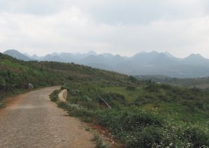 Description: Chain of mountains seen from a road on the way from Gejiu town in Honghe prefecture in southeastern Yunnan province in China to a viewpoint of the town and its lake way below.